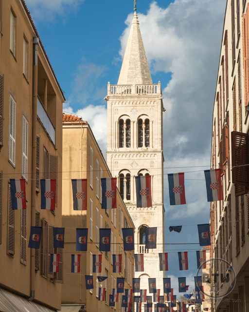 The Bell Tower in Zadar, Croatia, with Croatian flags in the foreground