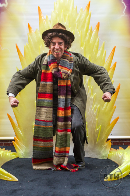 Aaron dressed as the Fourth Doctor posing in front of a Dragon Ball flame