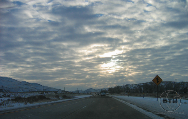 A wintery highway in Idaho under cloudy skies