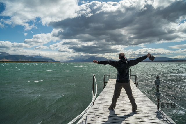 Aaron standing in the wind on a dock in Puerto Natales