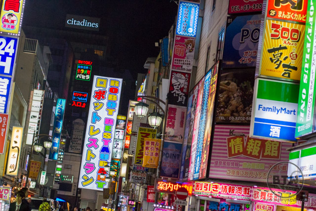 The colorful street lined with signs at night in Shinjuku, Tokyo, Japan