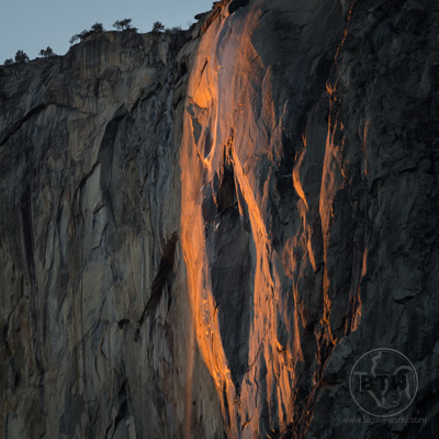 The sun glowing on Horsetail Fall, creating the famed Firefall phenomenon and making the rock look like a lava leviathan in Yosemite National Park | BIG tiny World Travel
